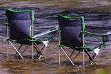 Two folding chairs in water
